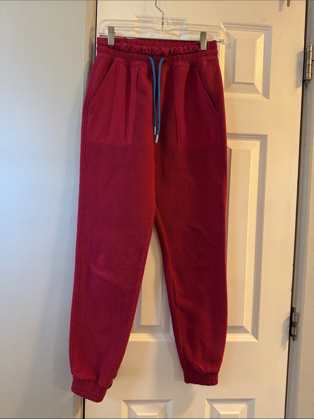 cotopaxi Raspberry Red Fleece Joggers with Blue Drawstring